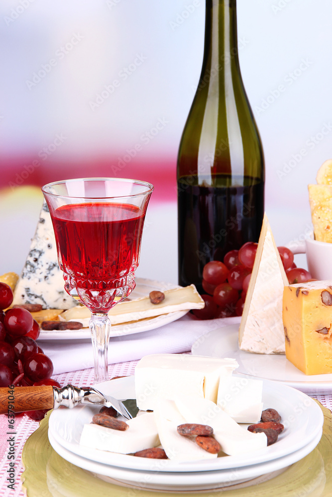 Assorted cheese plate , grape and wine glass