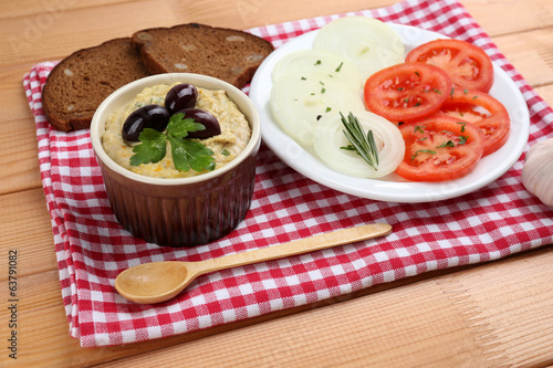 Bowl of tasty fresh hummus with olives