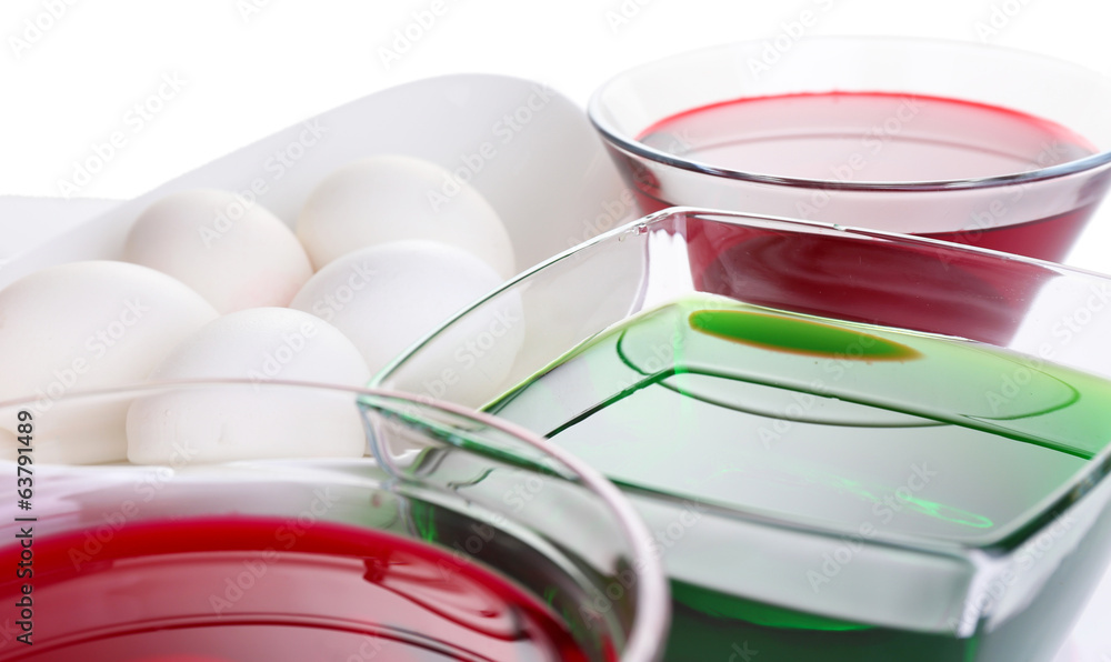 Eggs with liquid colour in glass bowls close up Eggs with liquid colour in glass bowls close up