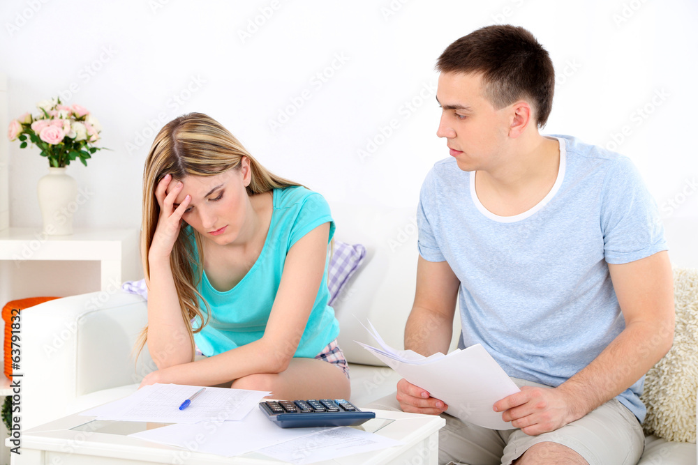 Young couple calculating finance at desk, Young couple calculating finance at desk,