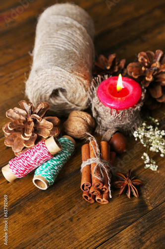 Composition with natural bump, candle, thread, cinnamon sticks