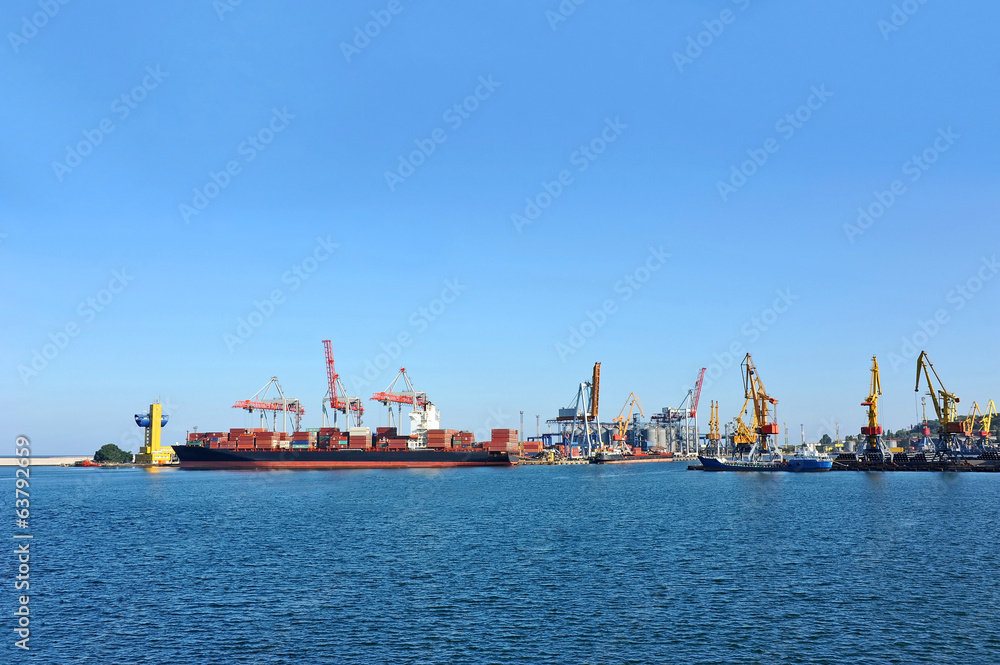 Fototapeta premium Container stack and ship under crane bridge