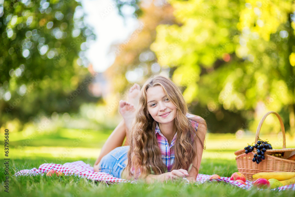 Beautiful girl having a picnic in park. Beautiful girl having a picnic in park.