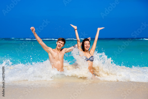young loving happy couple on tropical beach