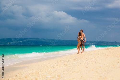 young loving happy couple on tropical beach