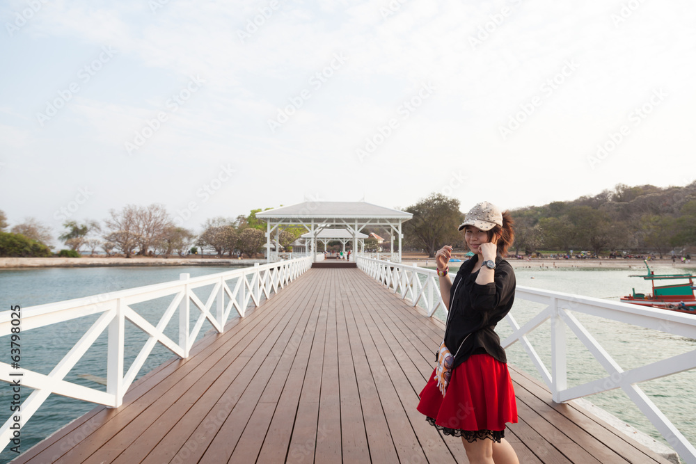 Asian women black shirt. Standing on wooden bridge Asian women black shirt. Standing on wooden bridge