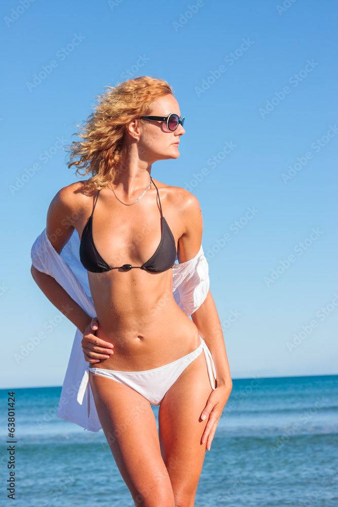 Woman in white shirt on the beach