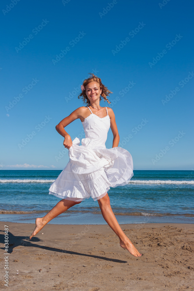 Young woman in white dress on the beach Young woman in white dress on the beach