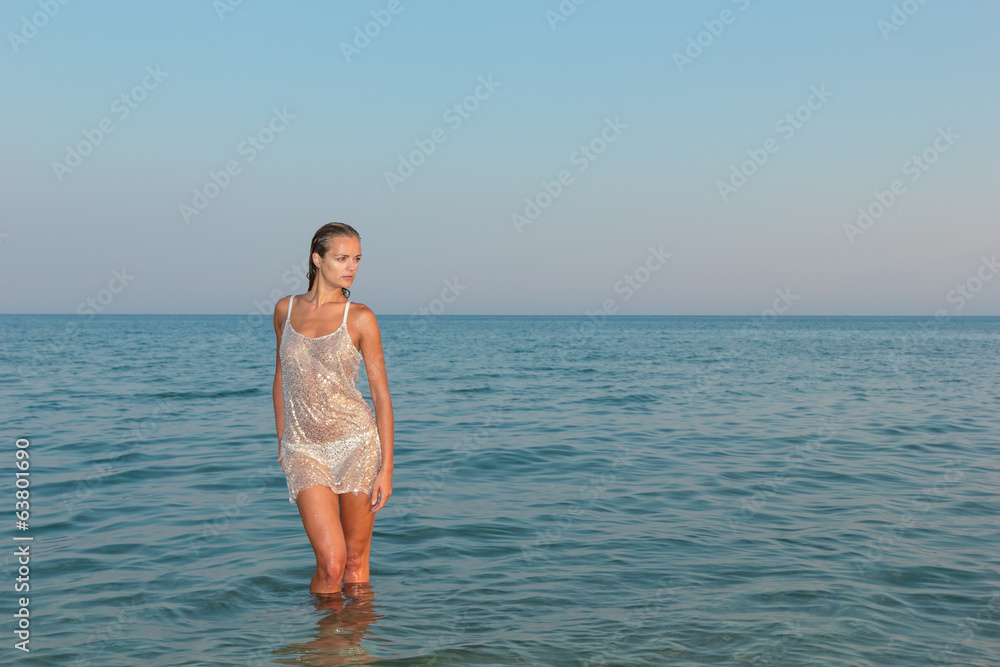 Woman on the beach in the evening Woman on the beach in the evening
