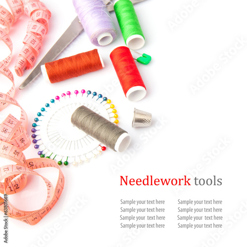 Sewing tools, thread, scissors, pins and measure type on white