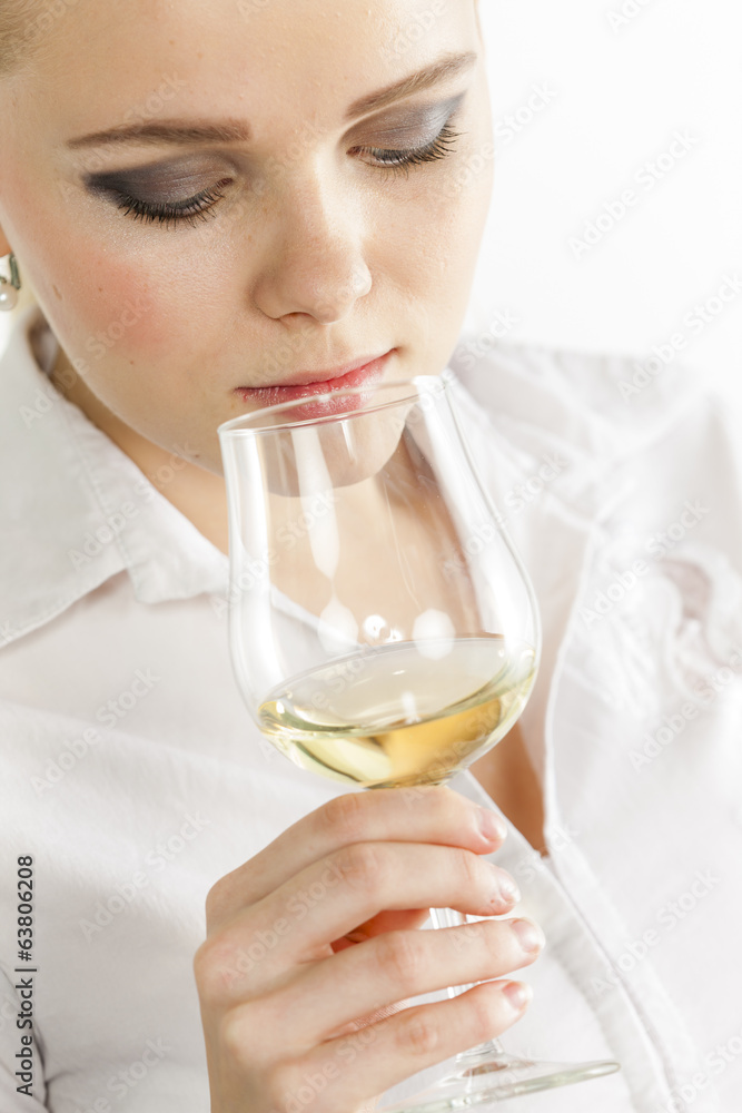 portrait of young woman tasting white wine portrait of young woman tasting white wine