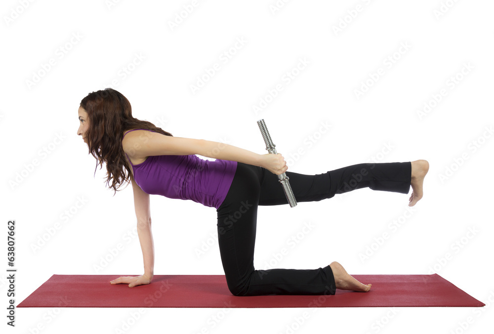 Fitness woman doing kneeling triceps kickback Fitness woman doing kneeling triceps kickback