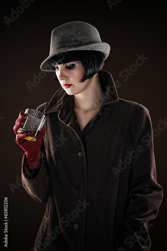 beautiful fashionable woman in the image of the detective