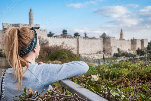 Young beautiful woman is watching for Jerusalem old town wall, I photo
