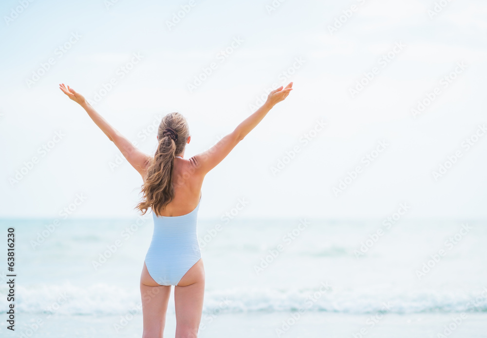 Young woman in swimsuit rejoicing at seaside Young woman in swimsuit rejoicing at seaside