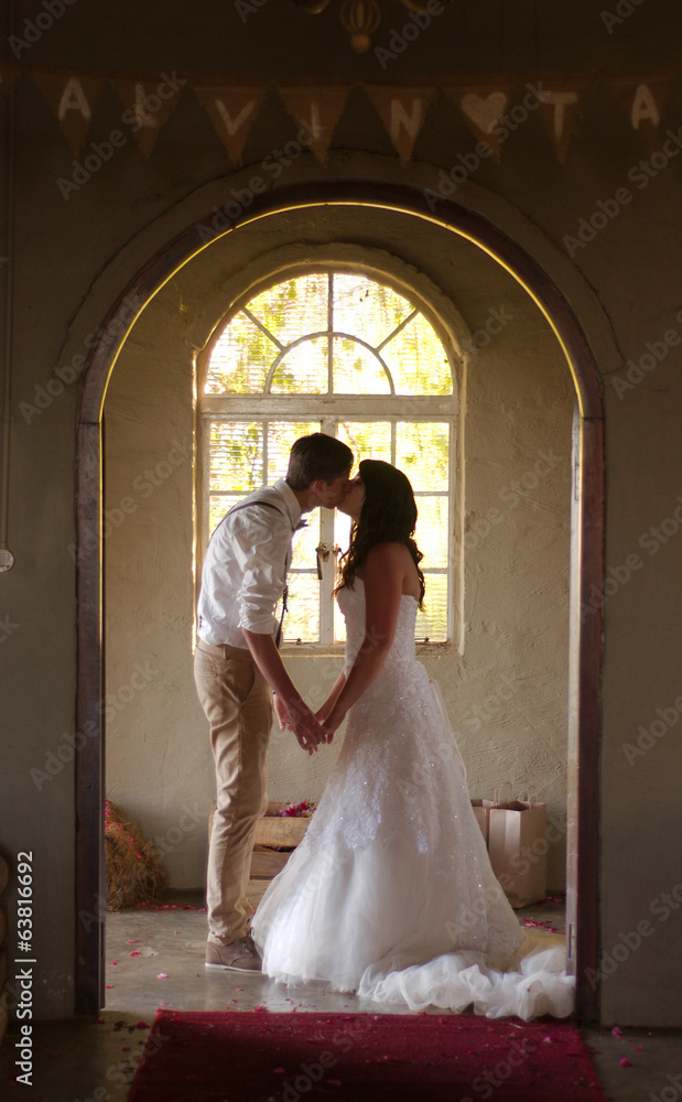 Bride and groom kissing inside church