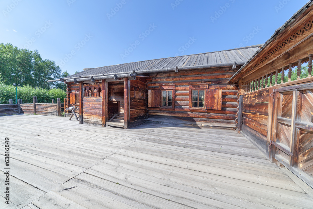 Wooden houses in the street in village. Museum of architecture Wooden houses in the street in village. Museum of architecture