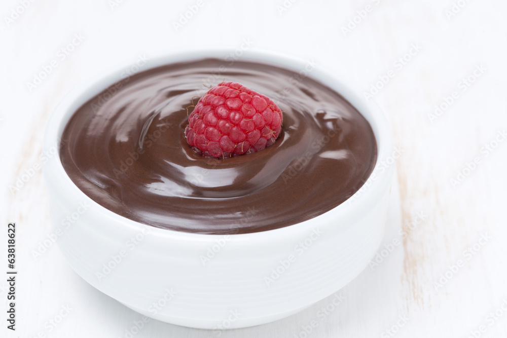 chocolate sauce and fresh raspberries on white wooden table chocolate sauce and fresh raspberries on white wooden table