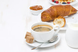 sweet breakfast with black coffee, croissants and orange jam