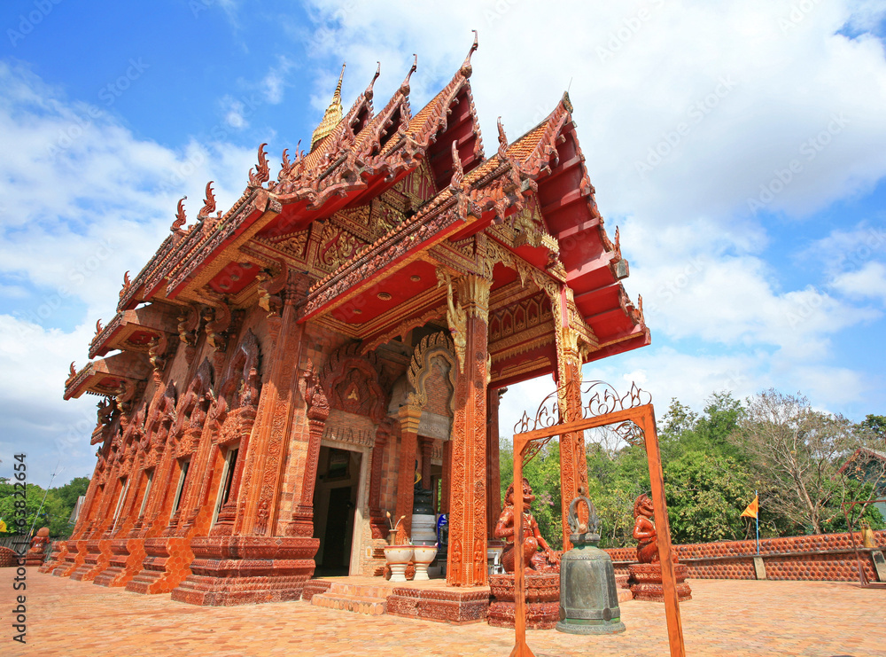 Red Thai temple against blue sky in Ubon