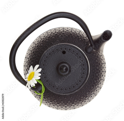 Teapot with chamomile flower isolated on white