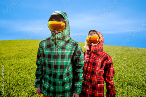 couple in the ski suits standing in the green field © rh2010