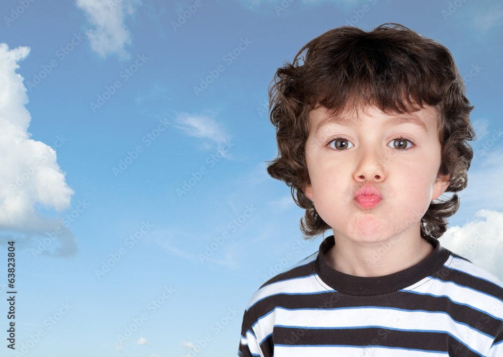 Funny child making grimace throwing a kiss Funny child making grimace throwing a kiss