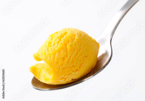 Yellow ice cream on a spoon photo
