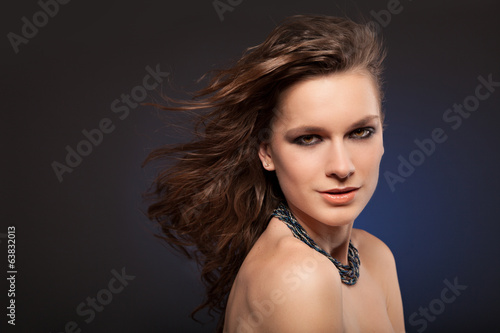 Portrait of beautiful sexy female model on dark background