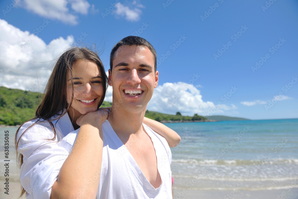 happy young couple have fun on beach happy young couple have fun on beach