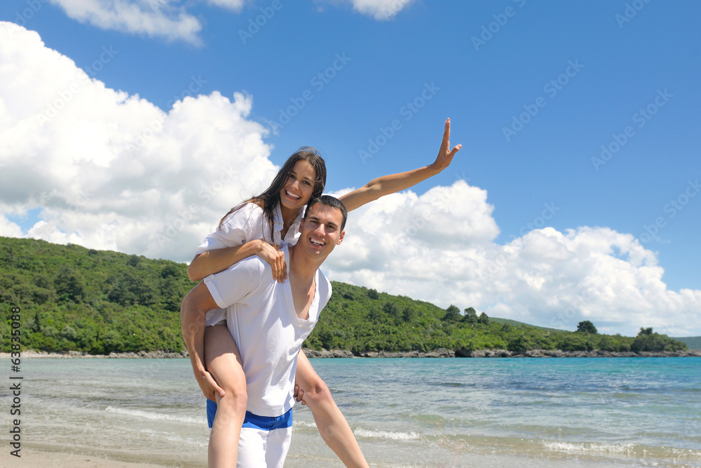 happy young couple have fun on beach