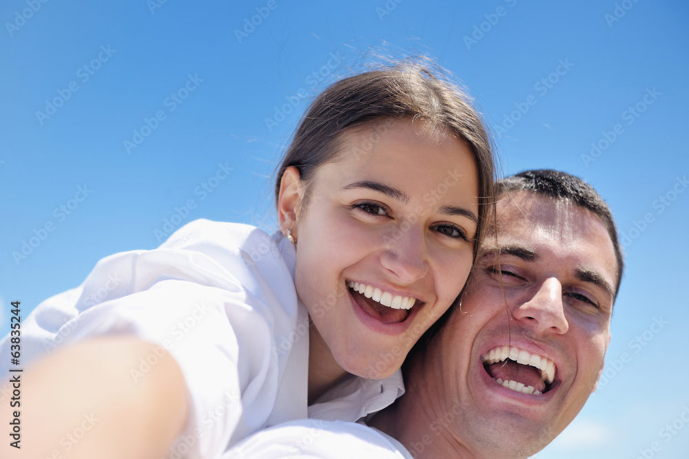 happy young couple have fun on beach happy young couple have fun on beach