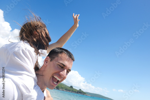 happy young couple have fun on beach