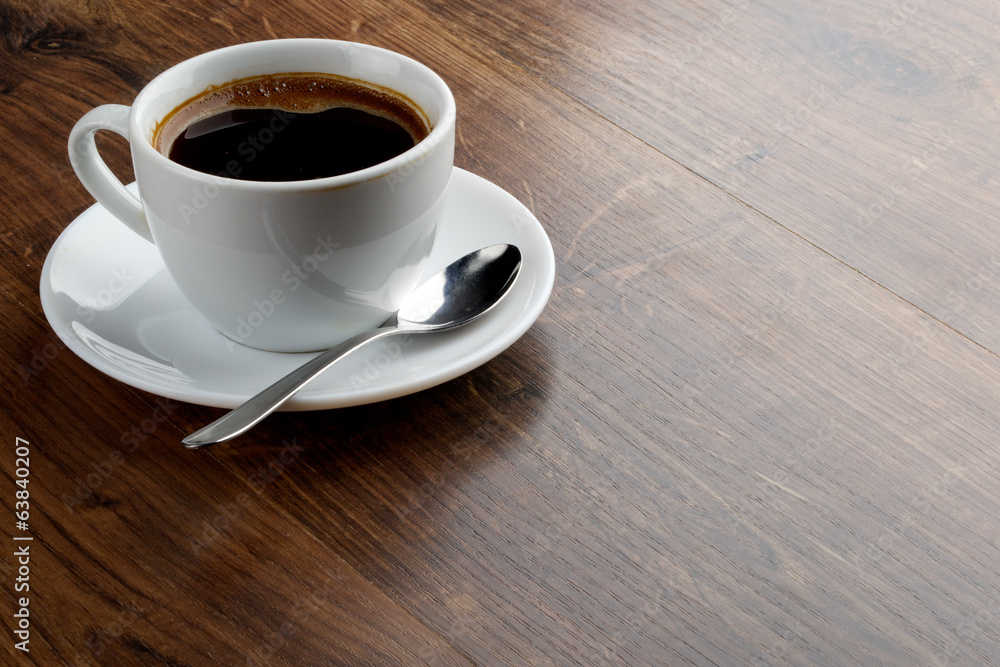 Coffee cup on a wooden table. Dark background. Coffee cup on a wooden table. Dark background.