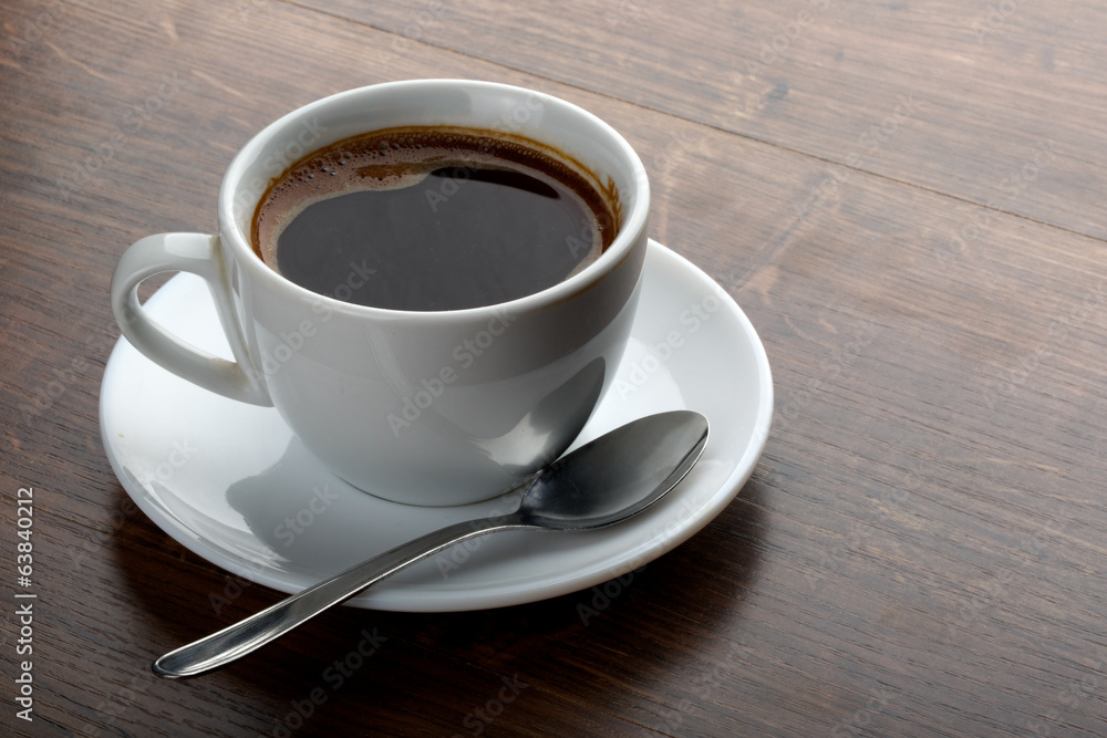 Coffee cup on a wooden table. Dark background. Coffee cup on a wooden table. Dark background.