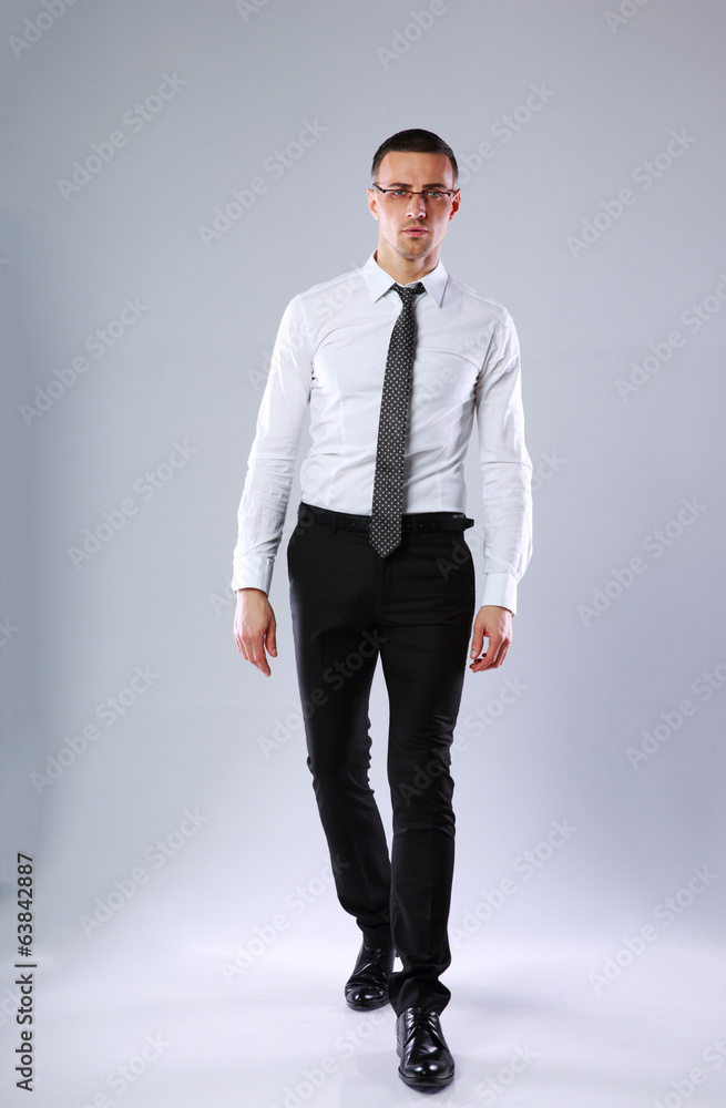 Studio shot of a confident businessman on gray background Studio shot of a confident businessman on gray background