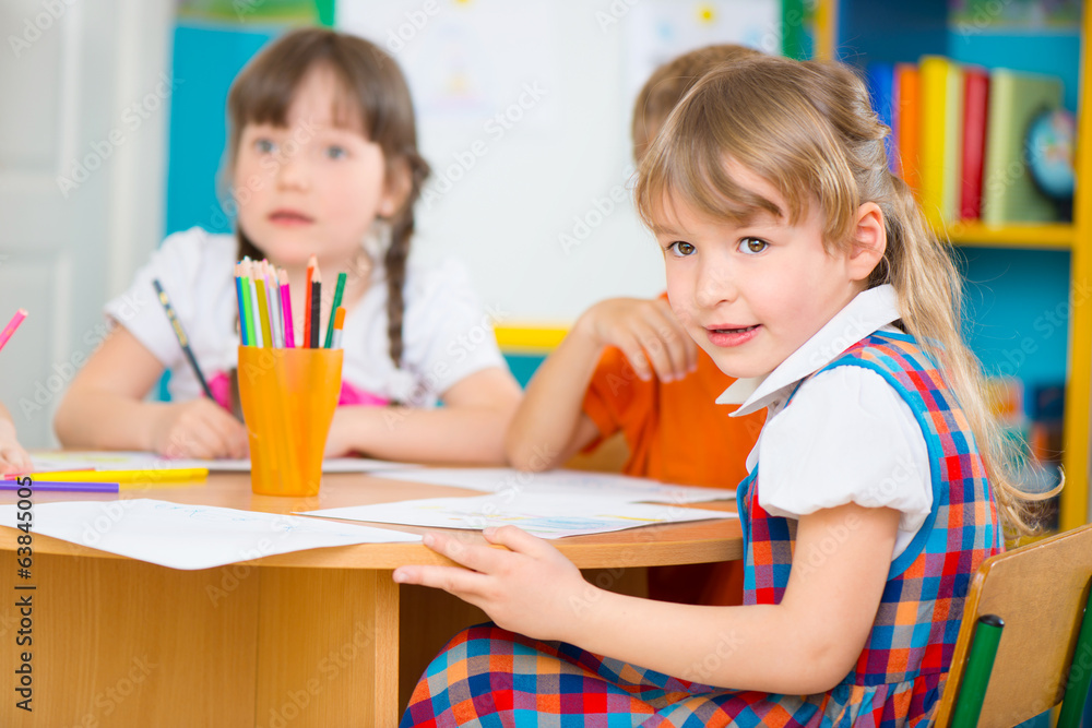 Two little girls drawing at kindergarten Two little girls drawing at kindergarten