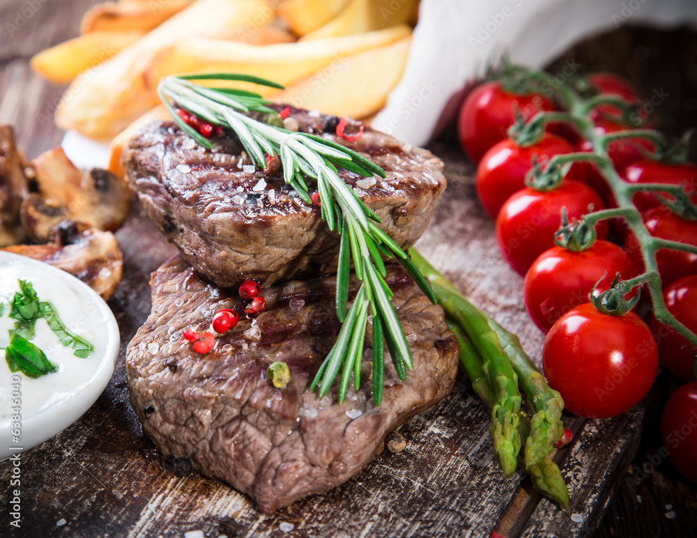 Beef steak on wooden table Beef steak on wooden table