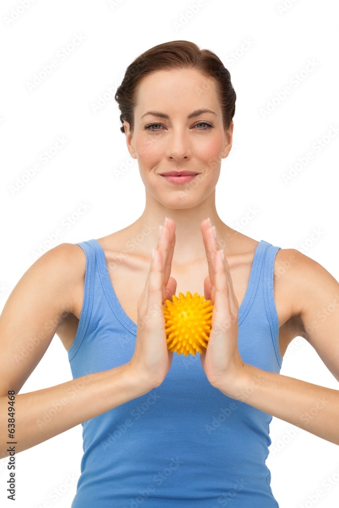 Portrait of a content young woman holding stress ball Portrait of a content young woman holding stress ball