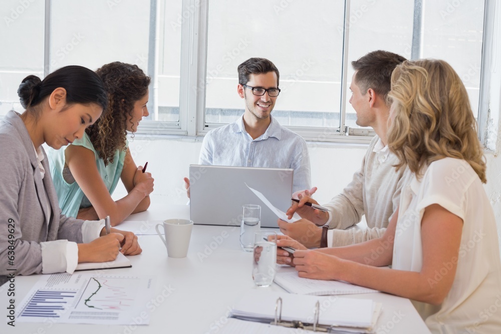 Casual businessman talking to team during meeting Casual businessman talking to team during meeting