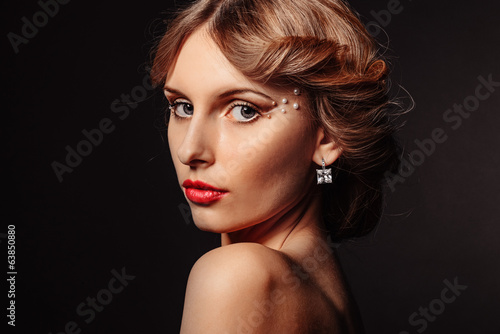 Beauty portrait of beautiful blond girl on black background