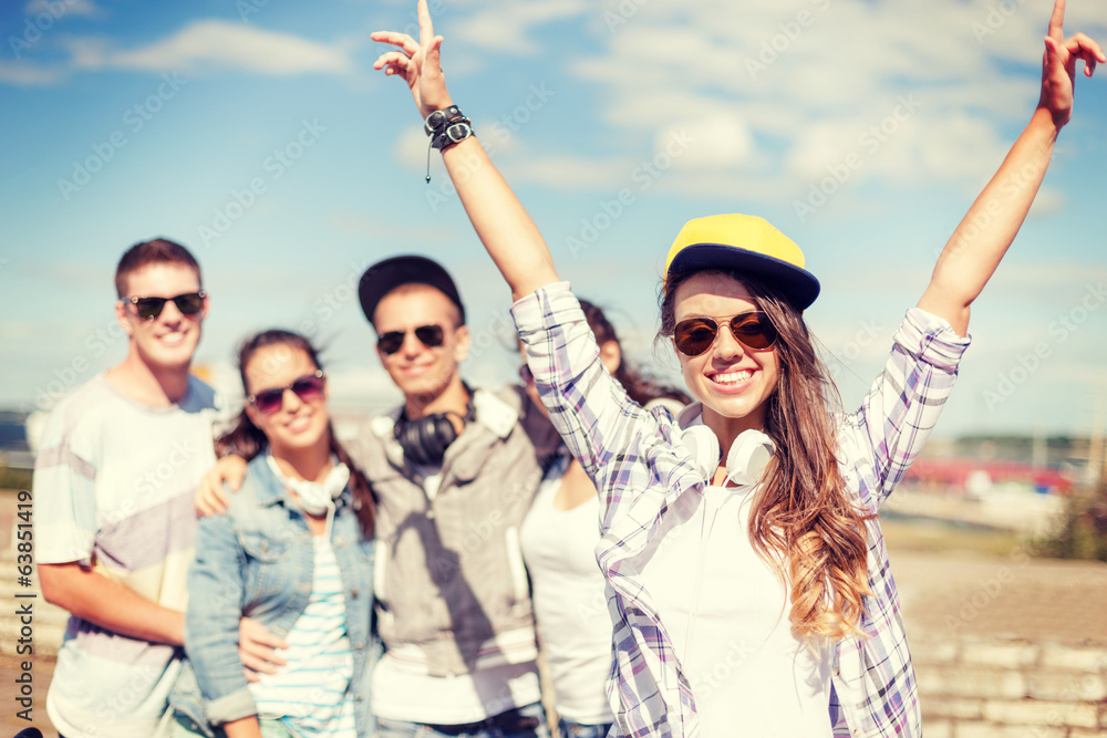 teenage girl with headphones and friends outside teenage girl with headphones and friends outside
