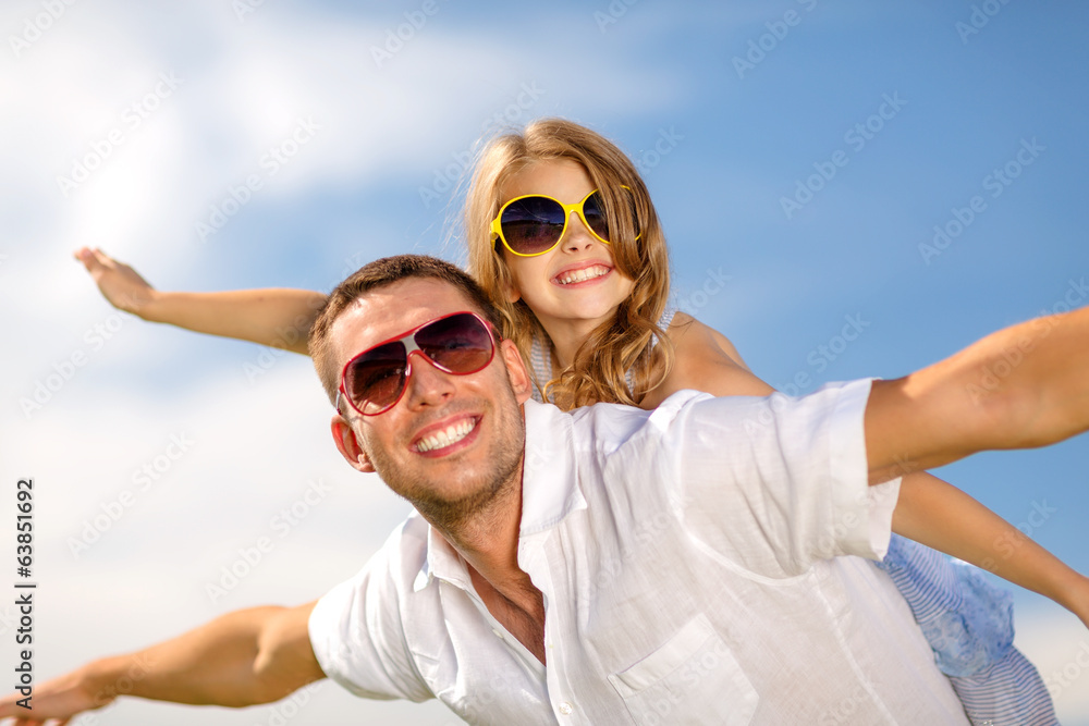 happy father and child in sunglasses over blue sky happy father and child in sunglasses over blue sky