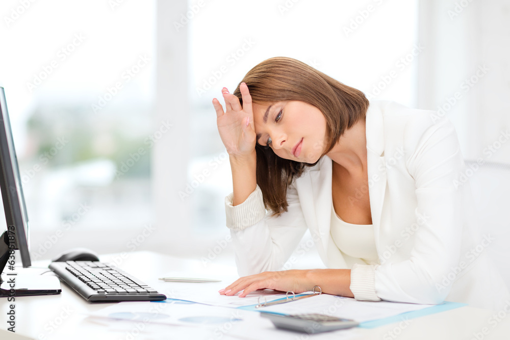 tired businesswoman with computer and papers tired businesswoman with computer and papers
