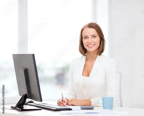 businesswoman with computer, documents and coffee