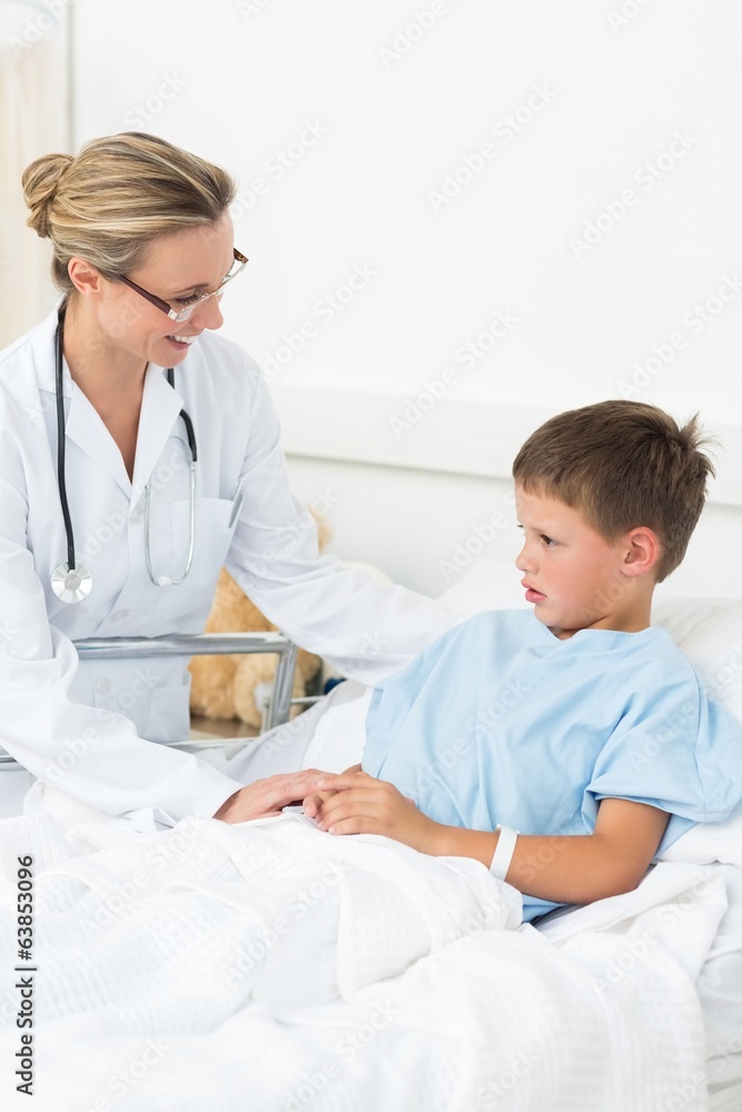 Doctor comforting sick boy in hospital Doctor comforting sick boy in hospital