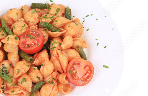 Close up of shells pasta with vegetables.