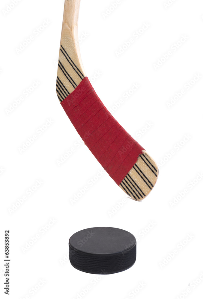 Obraz premium closeup of a hockey stick with a puck isolated on white