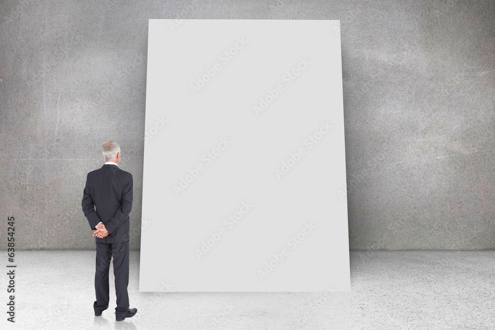Composite image of rear view of mature businessman posing Composite image of rear view of mature businessman posing