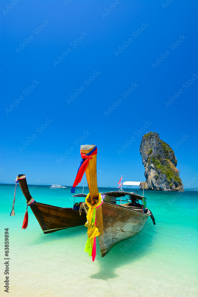 Fototapeta premium Cliff and boat in the amazing beach in tropical island in Krabi, Phuket, Thailand